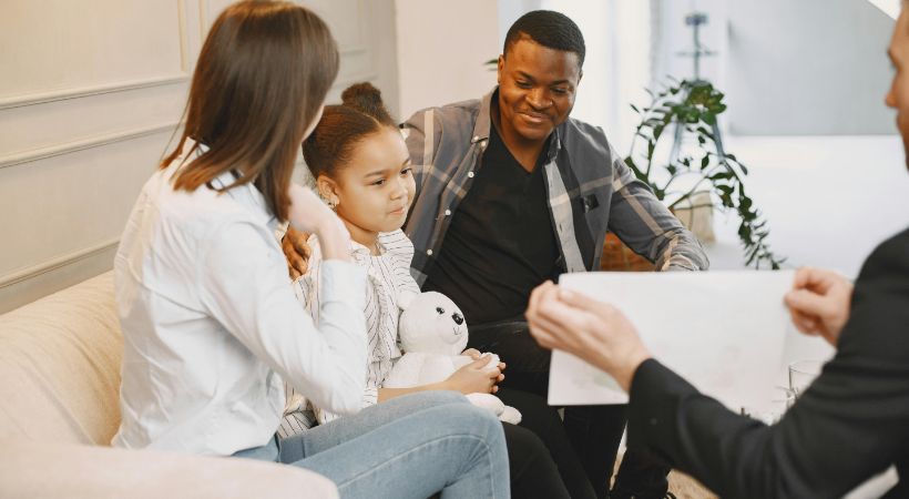 A child working through her emotions with her parents