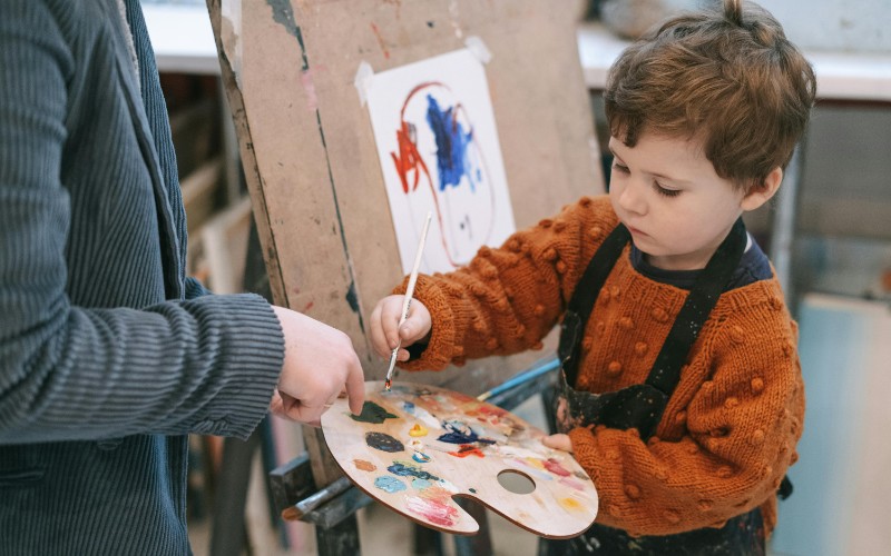 child painting in school