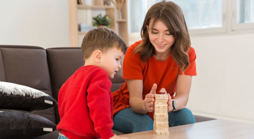 Woman helping an autistic child 